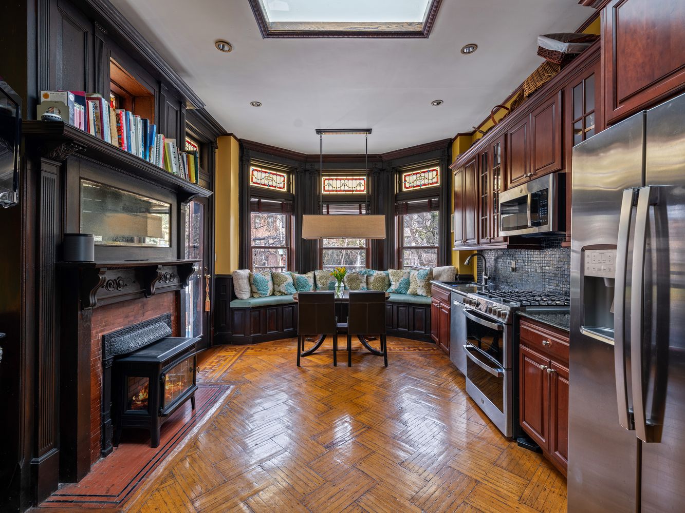 kitchen on the parlor level with a mantel, window seat and stained glass