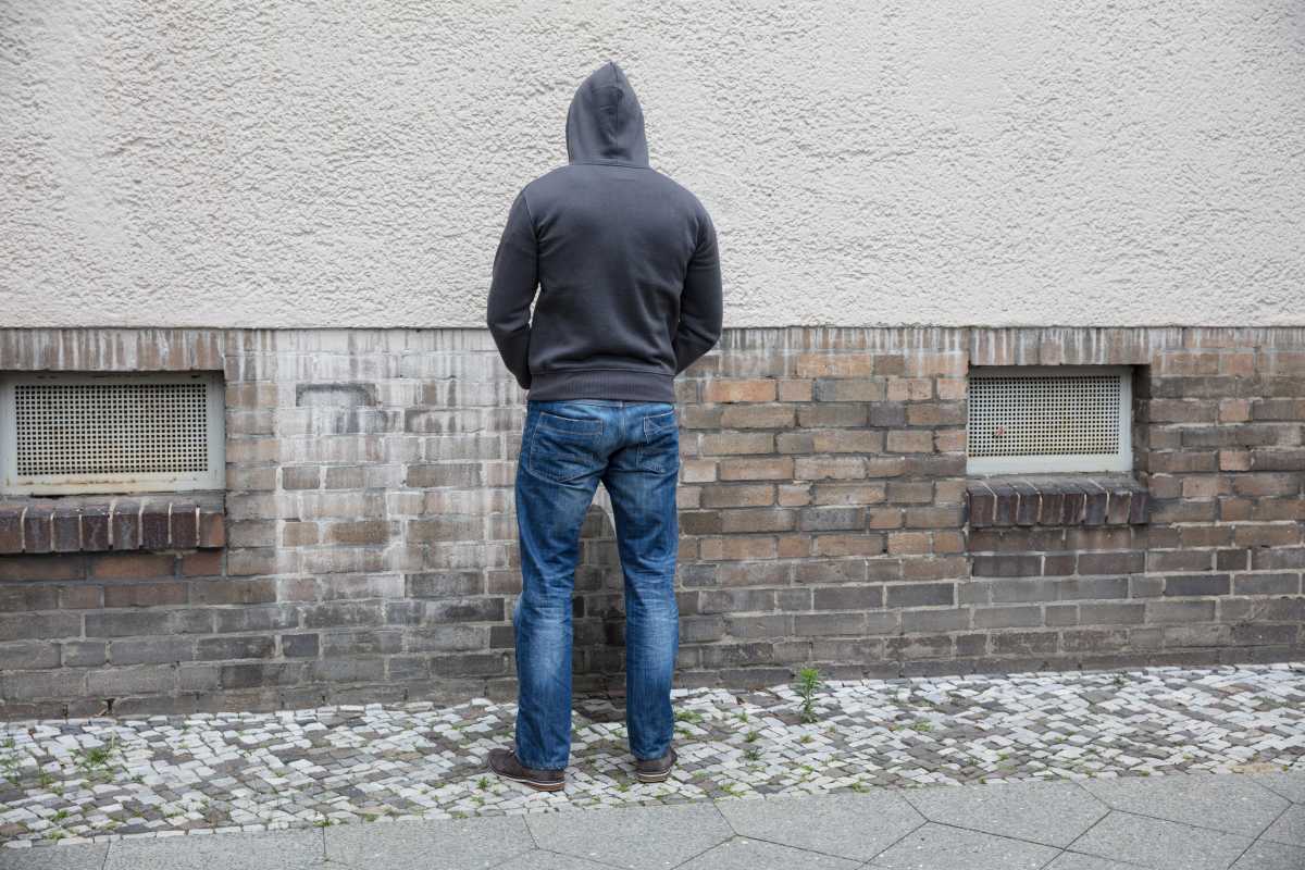 man peeing on sidewalk amid public urination complaints in nyc