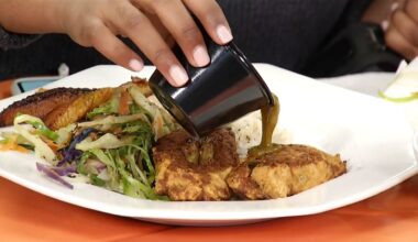 someone pours gravy or au jus on a dish of food