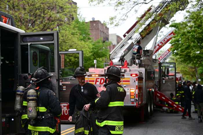 firefighters battlling a fire during the day