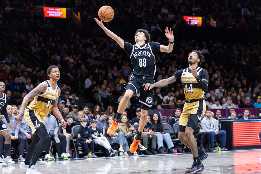 Nets guard Nolan Traore (88) shoots past Washington Wizards Leaky Black during the first half at Barclays Center, Sunday, April 5, 2026, in Brooklyn, NY. 