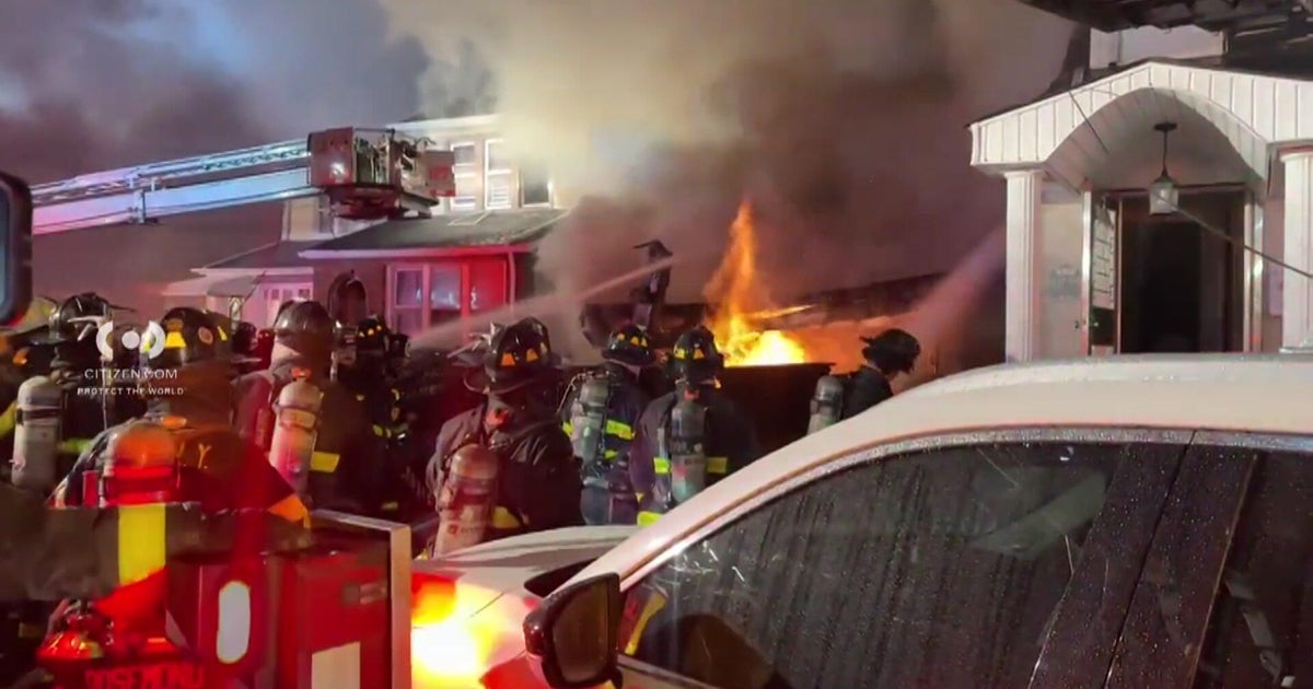 Massive fire in Queens damages homes as firefighters work to put flames out