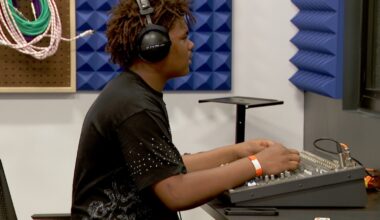 teenaged boy works a sound board in a recording studio