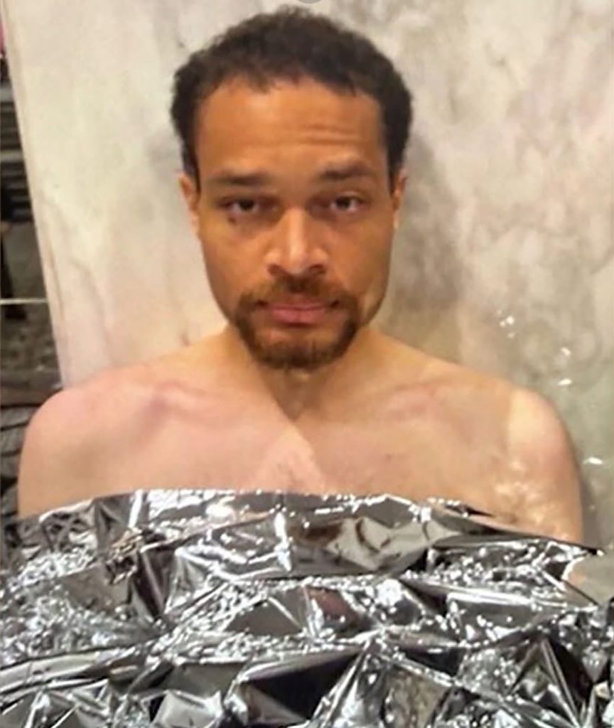 Booking photo of suspect Cole Tomas Allen wrapped in a thermal blanket.