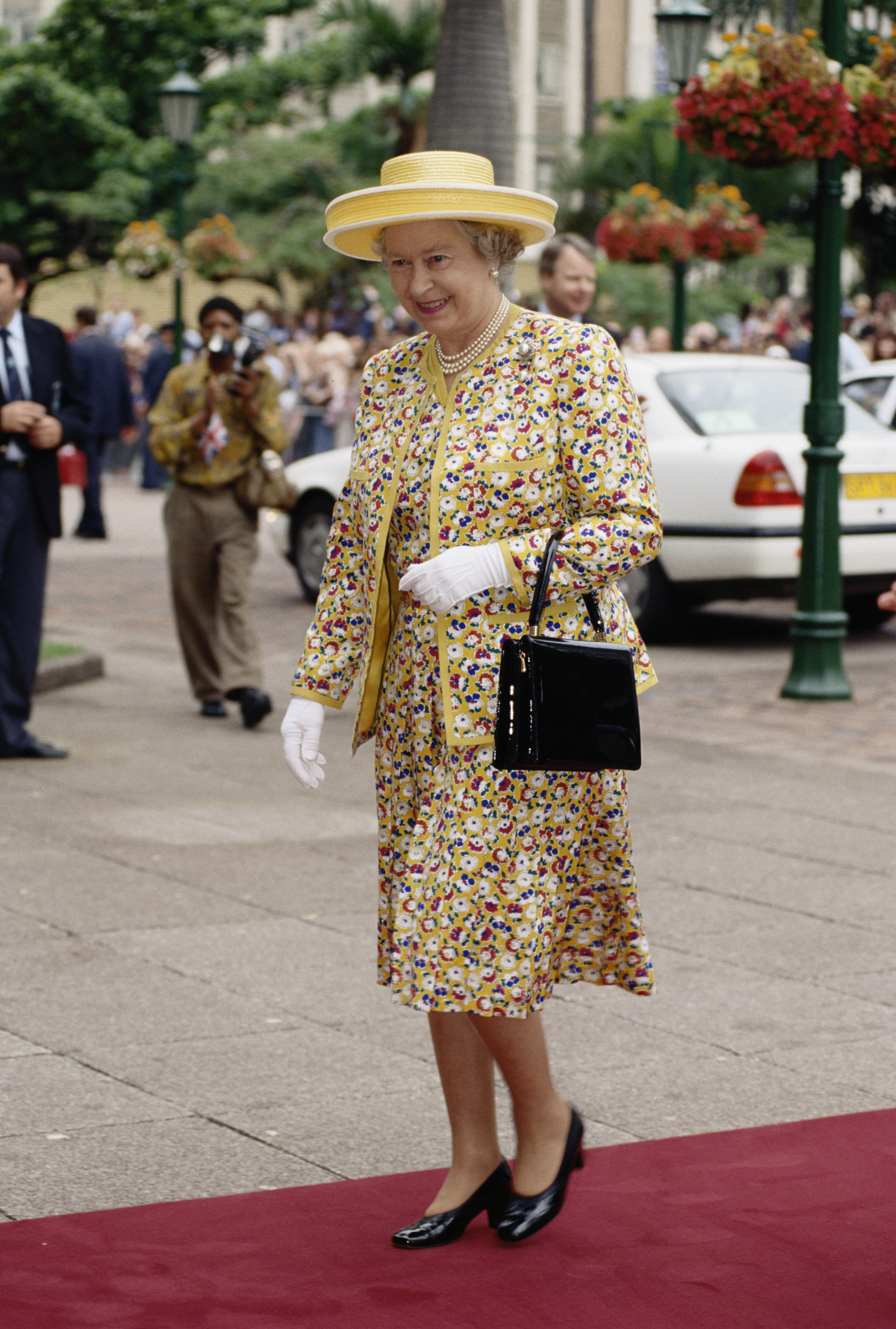 Queen Elizabeth wearing a yellow floral suit