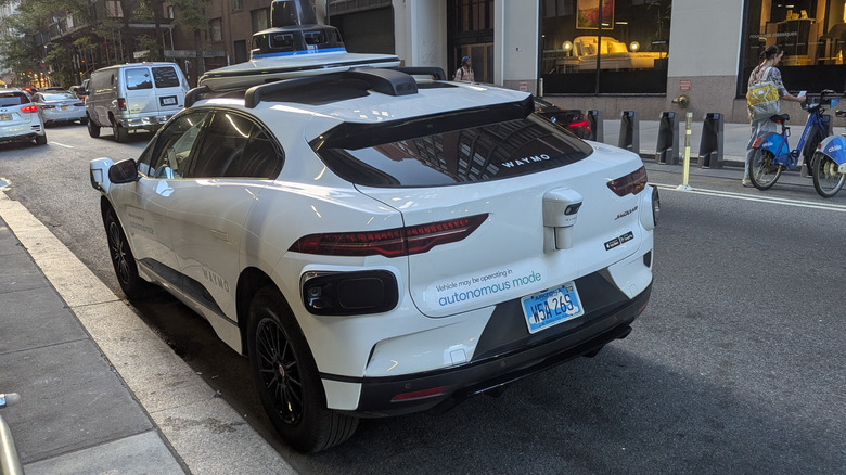 Rear 3/4 view of a Waymo robotaxi in New York City