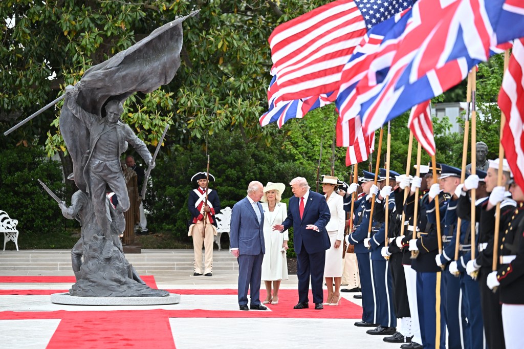 President Donald Trump, Queen Camila and Melania Trump walk in the White House Rose Garden following the state arrival ceremony.