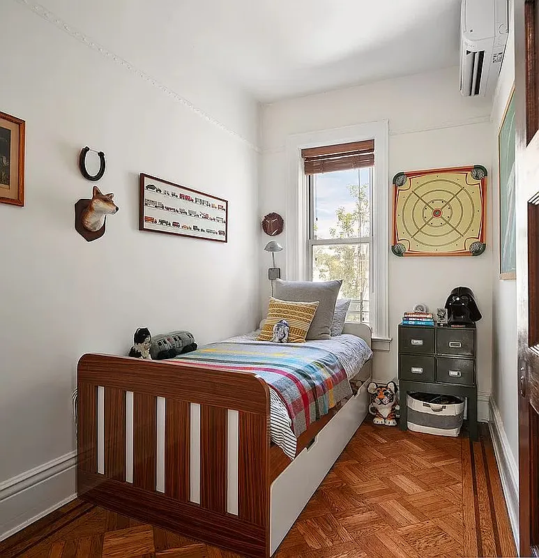 narrow bedroom with wood floor