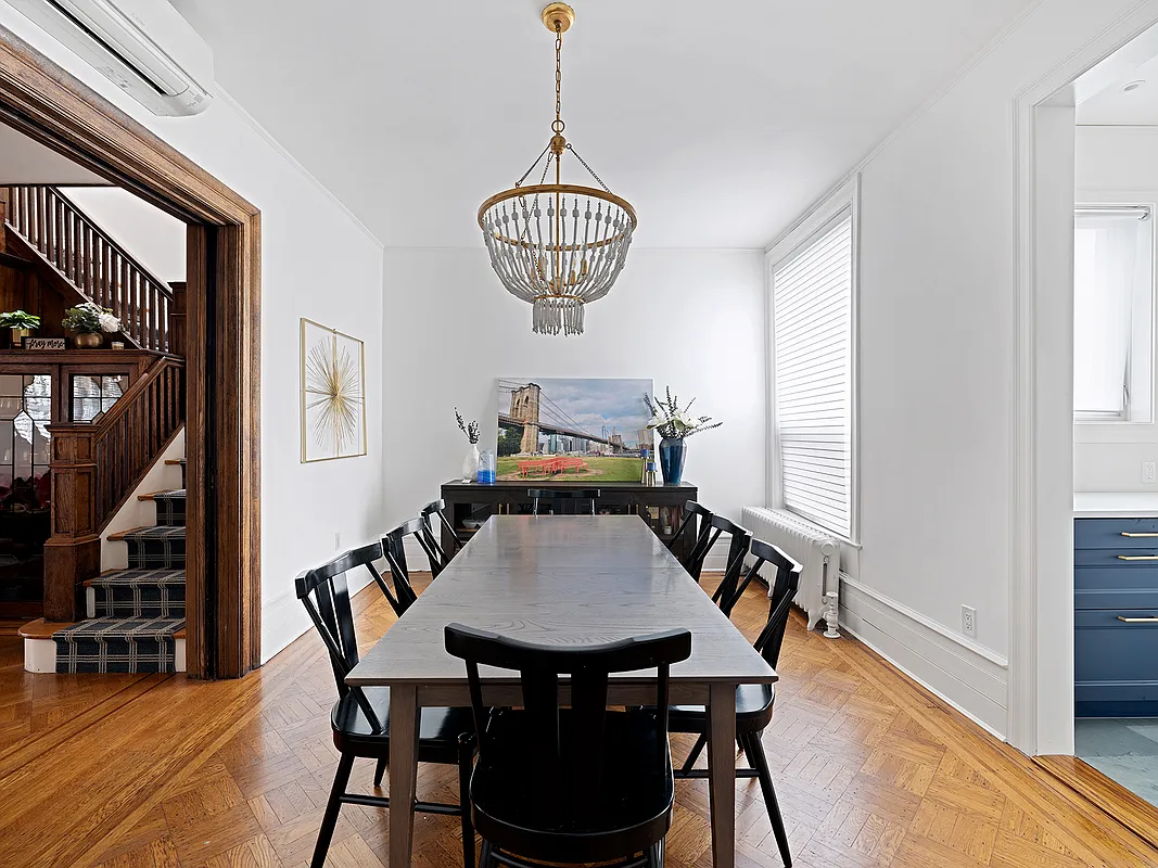 dining room with wood floor, view into kitchen