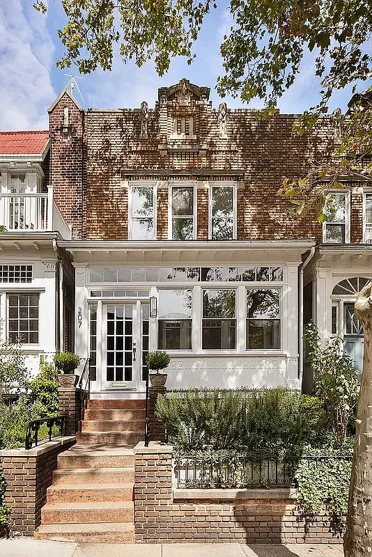 brick row house exterior with enclosed front porch