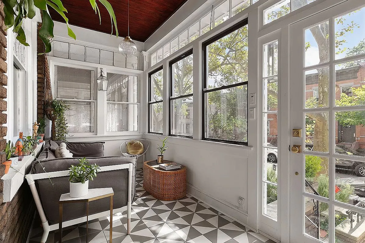 enclosed front porch with black and white tile floor