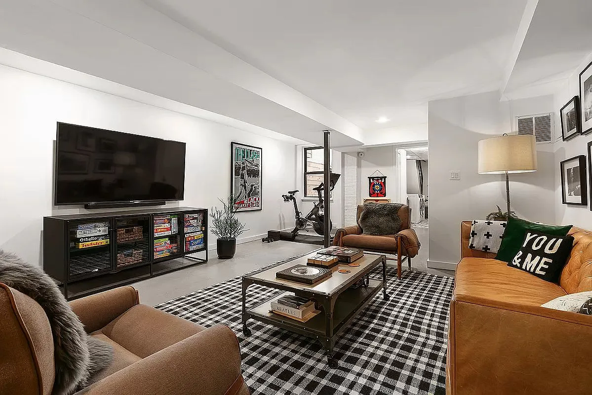 finished basement set up as a media room and a gym