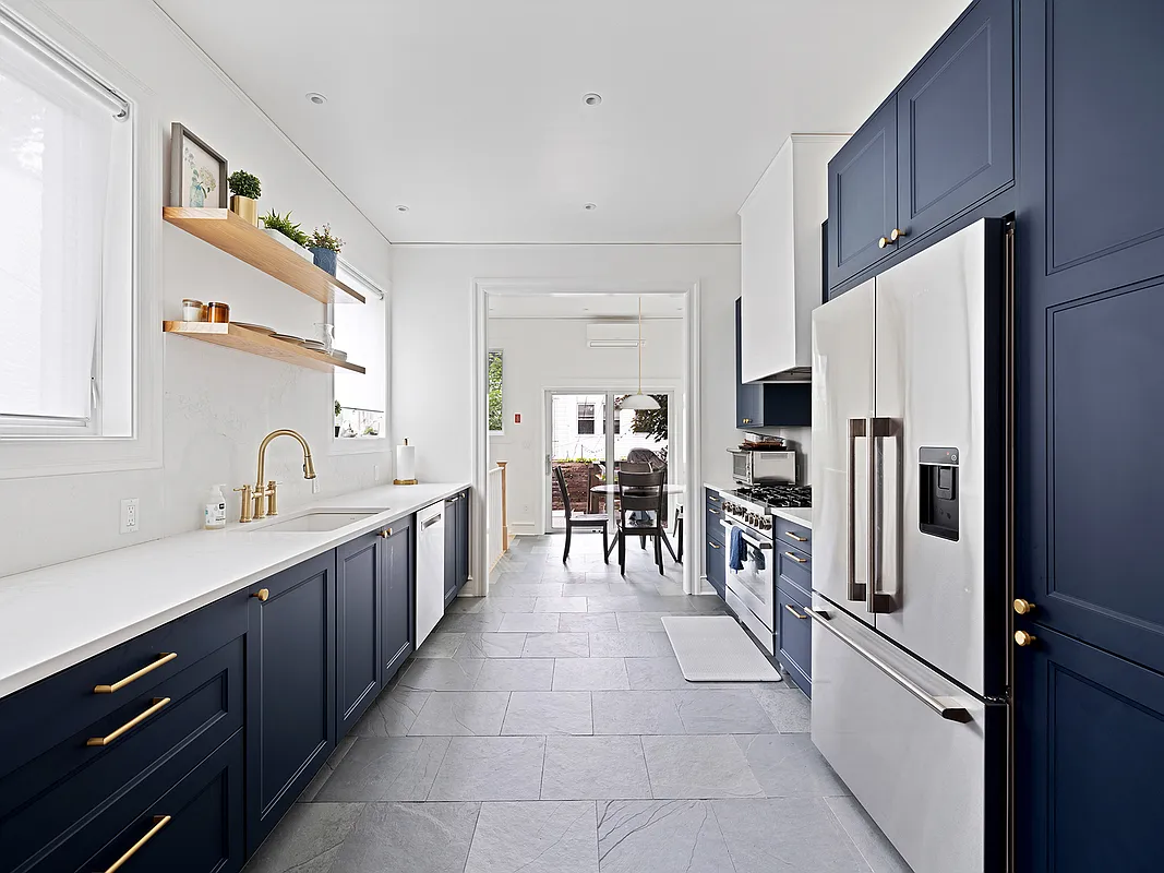 kitchen with blue cabinets, white counters
