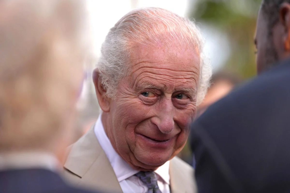 King Charles III descends from the aircraft upon arrival in Bermuda, marking a historic first visit as monarch.