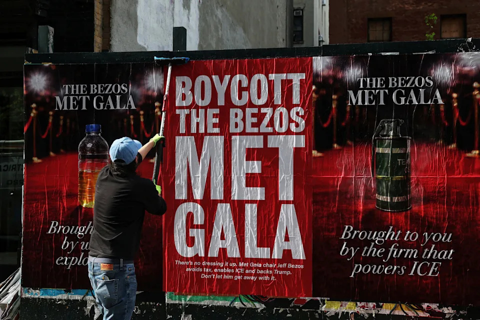 A man puts up a "Boycott the Bezos Met Gala" poster in the Midtown area of New York City, U.S., April 15, 2026. REUTERS/Shannon Stapleton