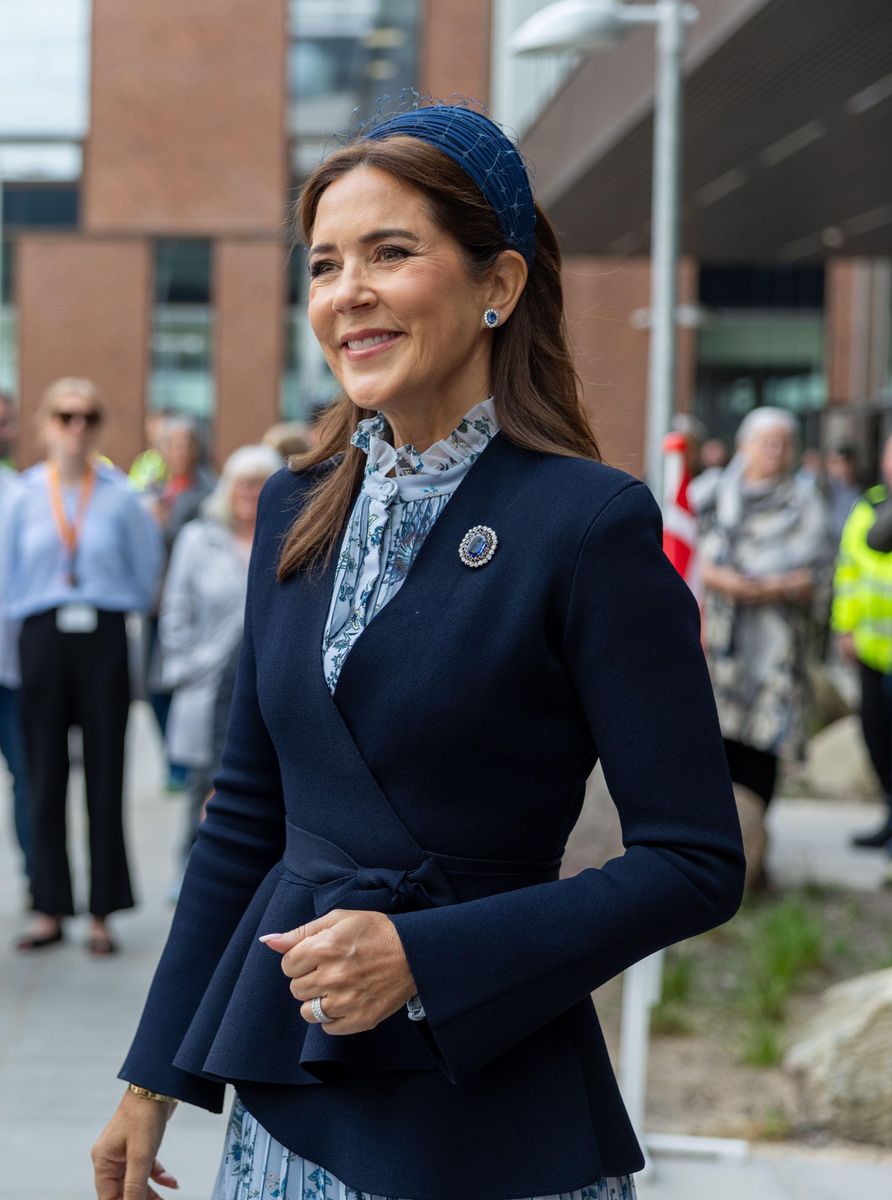 Queen Mary accessorized with sapphire and diamond earrings alongside a matching sapphire-and-diamond brooch delicately pinned to her jacket