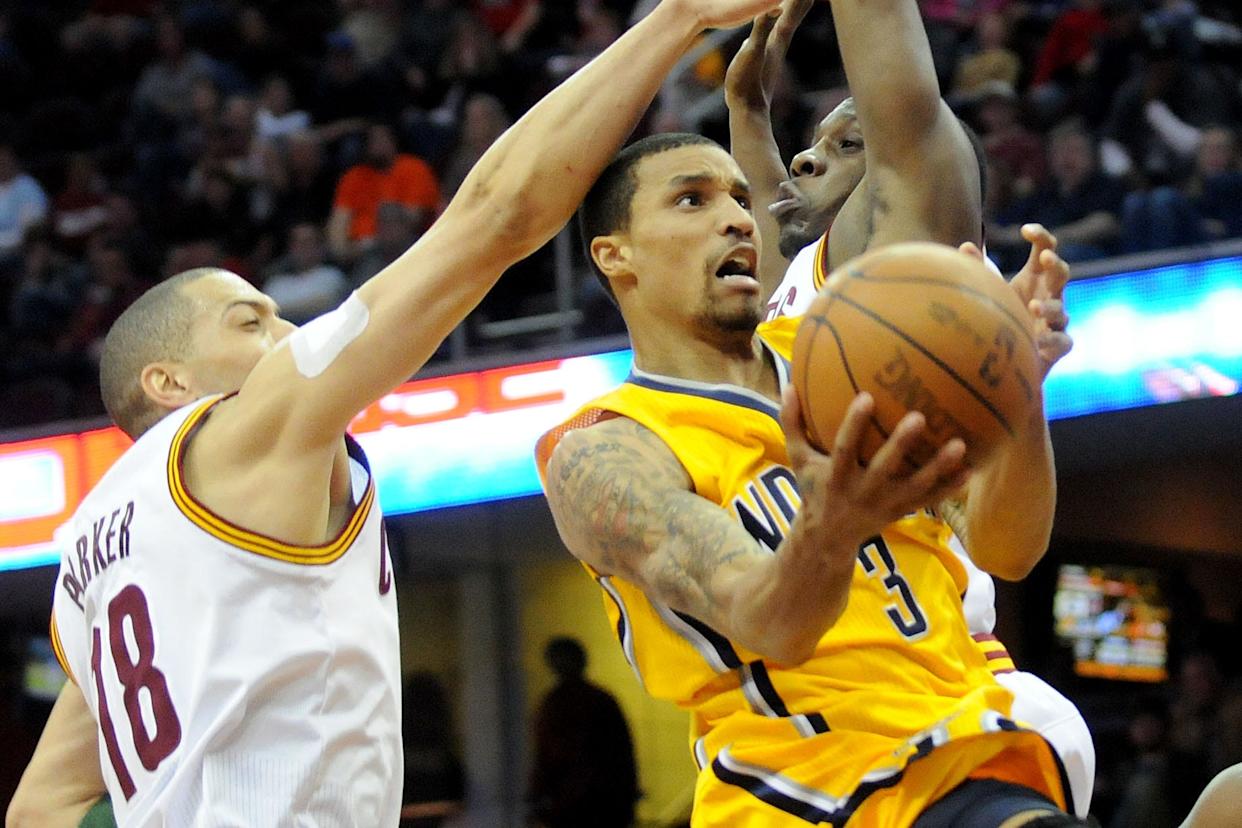 April 11, 2012; Cleveland, OH, USA: Indiana Pacers small forward Danny Granger (33) goes up for a shot between Cleveland Cavaliers shooting guard Anthony Parker (18) and forward Luke Harangody (44) during the game at Quicken Loans Arena. Mandatory Credit: Eric P. Mull-USPRESSWIRE