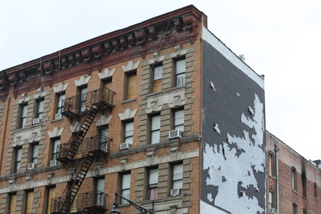 Windows were boarded up at 207 Dyckman Street in Upper Manhattan after a fire killed several people in the building.