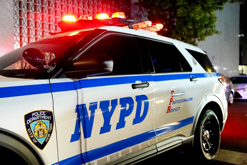 NYPD police cruiser with flashing lights.