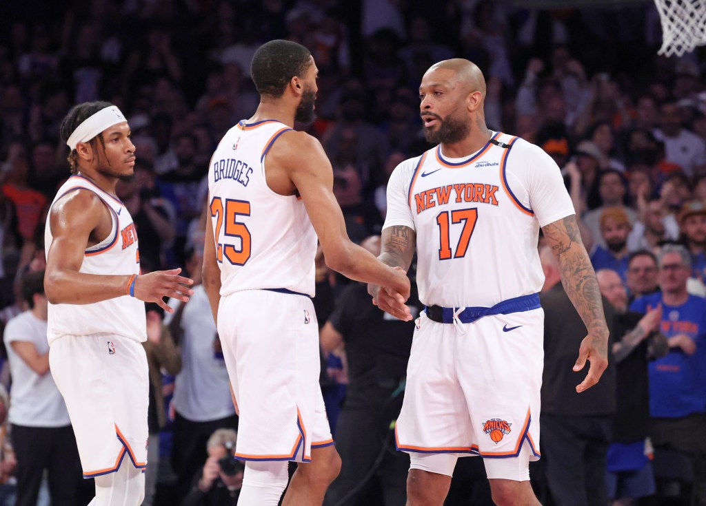New York Knicks forward P.J. Tucker #17, shakes hands with New York Knicks forward Mikal Bridges #25, as he checks into the game in the 4th quarter, as the Knicks beat the Celtics to advance to the Eastern Conference Finals. 