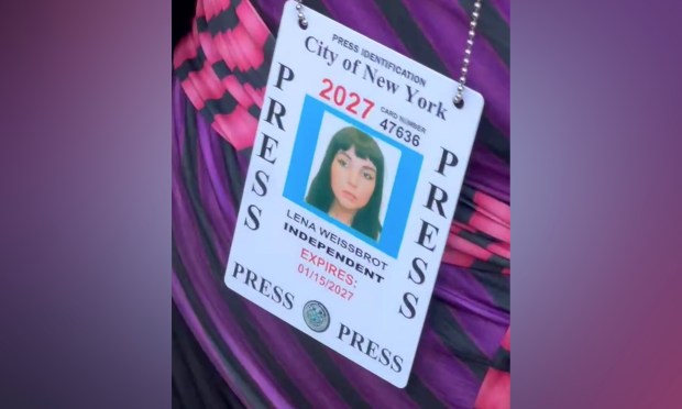 Lena Weissbrot, a Luigi Mangione supporter, displays her city-issued press credentials outside Manhattan Criminal Court on Monday.