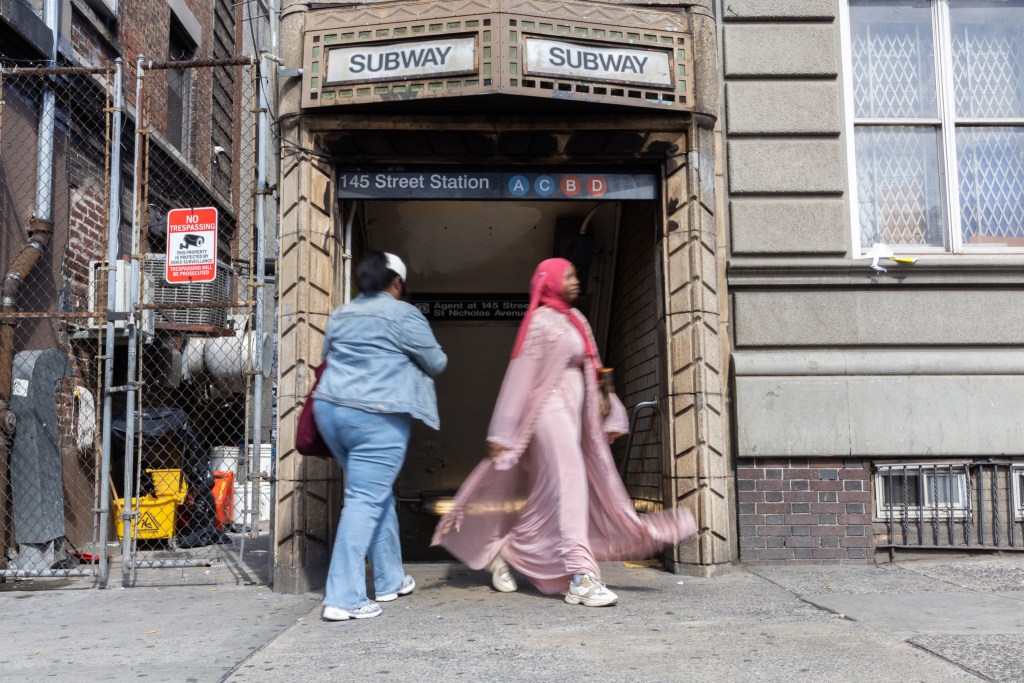 Commuters use a stairwell to enter and exit the 145th Street station in Harlem,