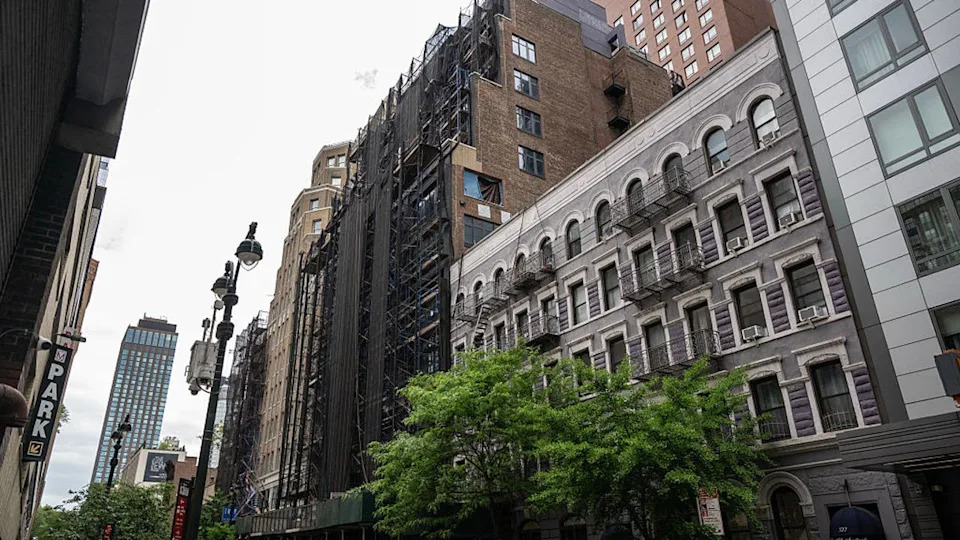 <div>Scaffolding outside a stalled condo conversion, left, at 335 W. 35th St. in New York, US, on Thursday, May 14, 2026. Commercial real estate lenders are selling off debt on struggling US assets, sometimes writing down as much as 85% of the loan's payoff amount. Photographer: Victor J. Blue/Bloomberg via Getty Images</div>