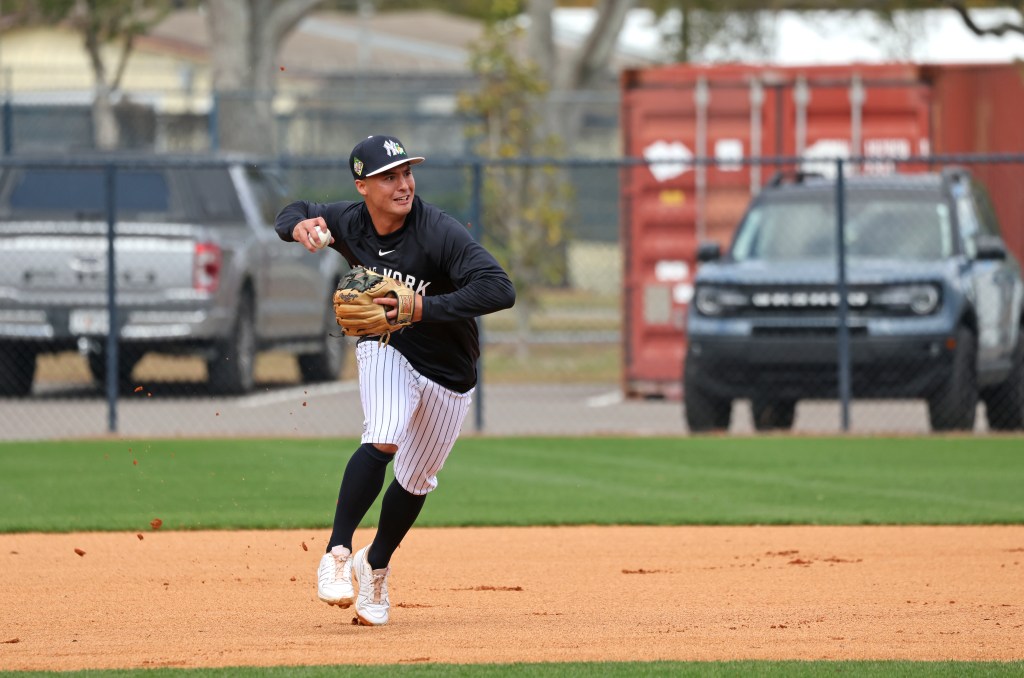 New York Yankees shortstop Anthony Volpe #11 fielding a ball during spring training.
