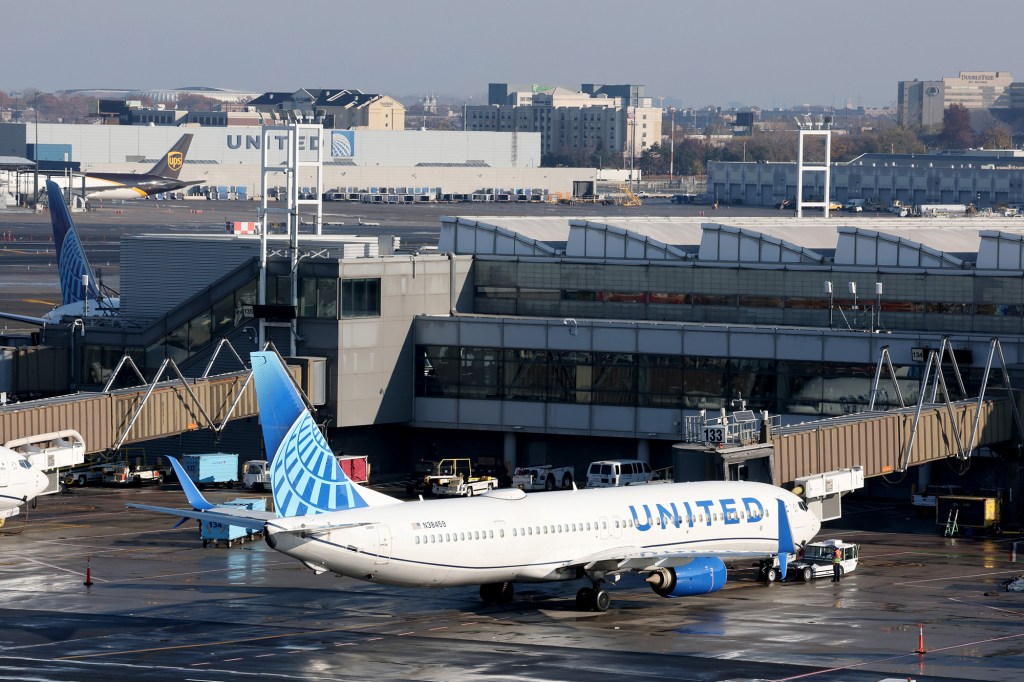 United Airlines plane at the gate with jet bridges attached.