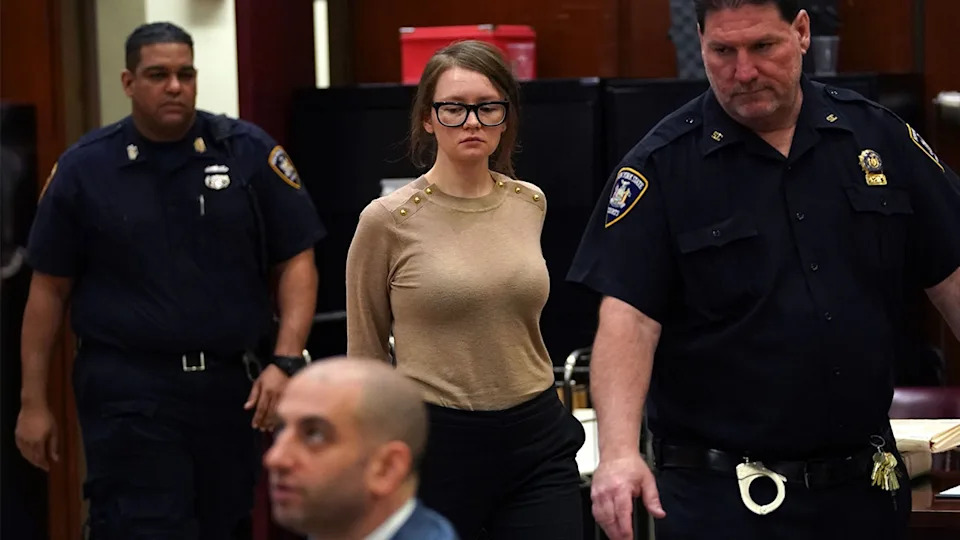 Anna Sorokin wearing a beige sweater seated in a courtroom