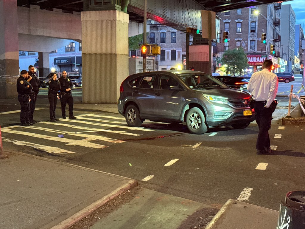 Police officers at the scene of a fatal hit and run on East 138th Street and Bruckner Boulevard in the Bronx.