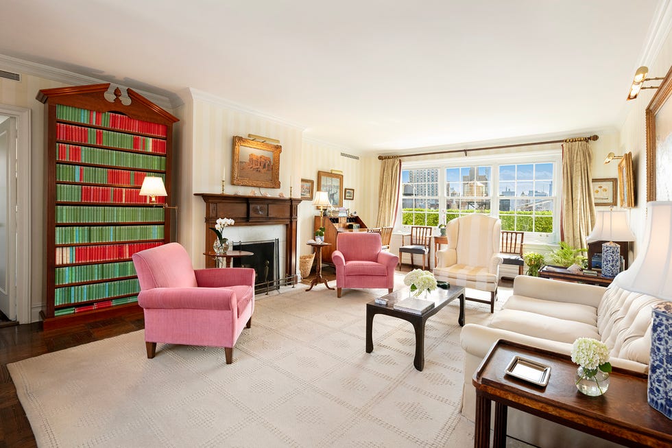Living room with bookshelves and seating area. Living room with bookshelves and seating area.