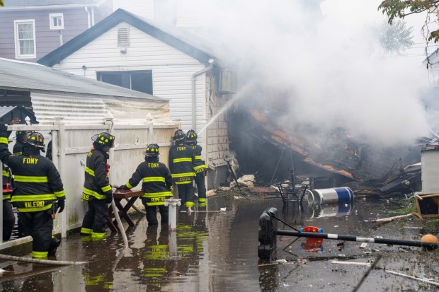 FDNY firefighters work the scene after a massive explosion on 130th St. in Queens on Thursday, April 30, 2026. (Theodore Parisienne / New York Daily News)