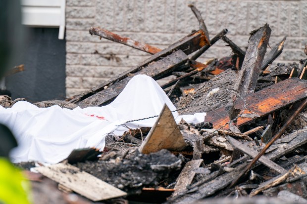 A body is pictured after a massive explosion on 130th St. in Queens on Thursday, April 30, 2026. (Theodore Parisienne / New York Daily News)