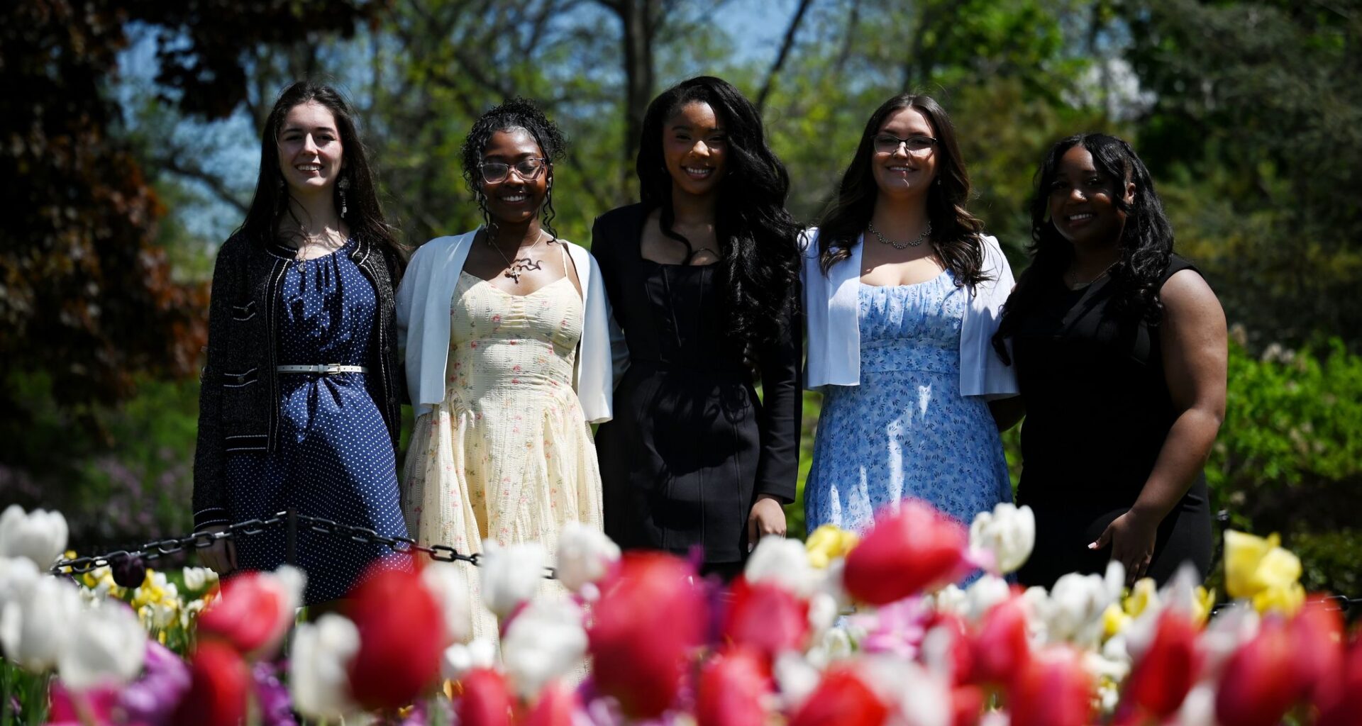 2026 Tulip Queen finalists; Olivia Rose, left, Trinity Tarver, Phylicia Hinton, Alexis Savoie and Syaira Liverpool, right, pose for a photo in the tulip beds at Washington Park on Thursday, May 7, 2026, in Albany, N.Y. (Will Waldron/Times Union)