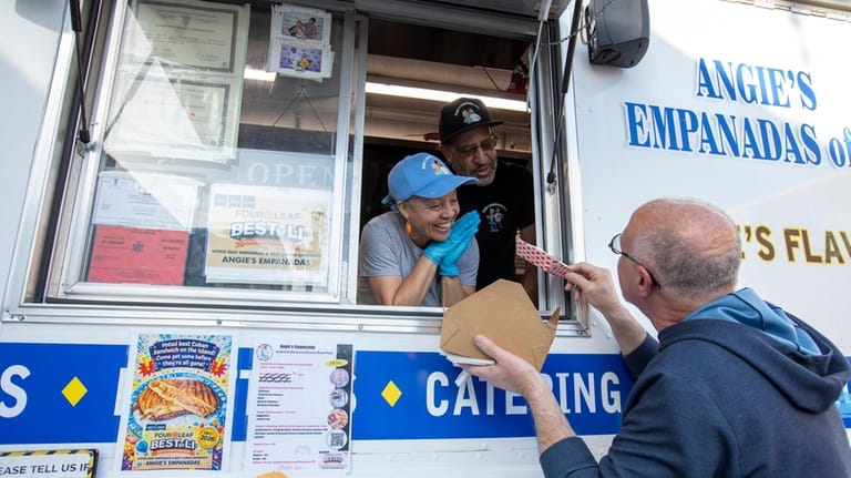Angie and Moe Pereira talk with customer Steven Gusmano at...