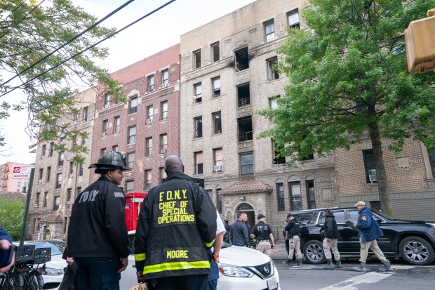 FDNY and Red Cross personnel are pictured outside an apartment building on Bainbridge Ave. in the Bronx after a fatal fire on Monday, May 11, 2026. (Barry Williams/ New York Daily News)