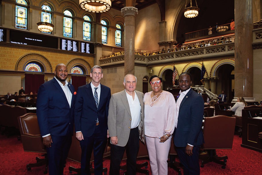 (L. to r.): Aaron Ambrose, Queens Regional Representative for Governor Hochul; Assemblyman Braunstein, Ron Naclerio, and Assemblymembers Hooks and Ander­son are photographed on the Assembly Floor.