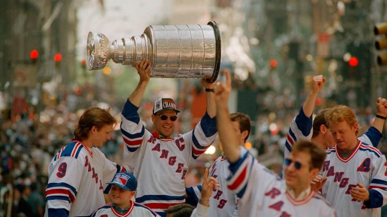 New York Rangers captain Mark Messier, joined by other members...
