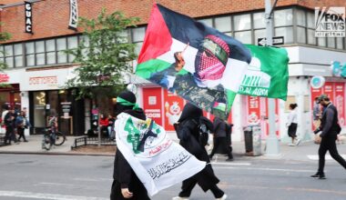 Masked protesters carry Hamas flags at NYC Manhattan protest Friday