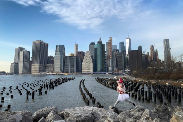 With One World Trade Center seen in the background, a little girl leaps across boulders forming a breakwater along the Brooklyn Bridge Park on Dec. 27, 2018, in the Brooklyn borough, of New York. (AP Photo/Wong Maye-E, File)