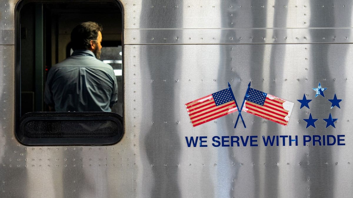 A conductor stands in a train of the Long Island Railroad