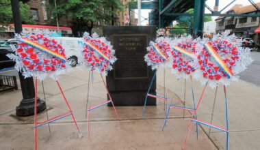 Wreaths at the Woodside Memorial Park Triangle at the corner of Woodside and Roo­sevelt Avenues. Photos Walter Karling