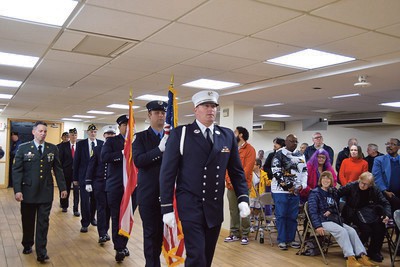 FDNY Ceremonial Unit leads in the Legionnaires of Post 1836 inside the hall to start the cere­mony.