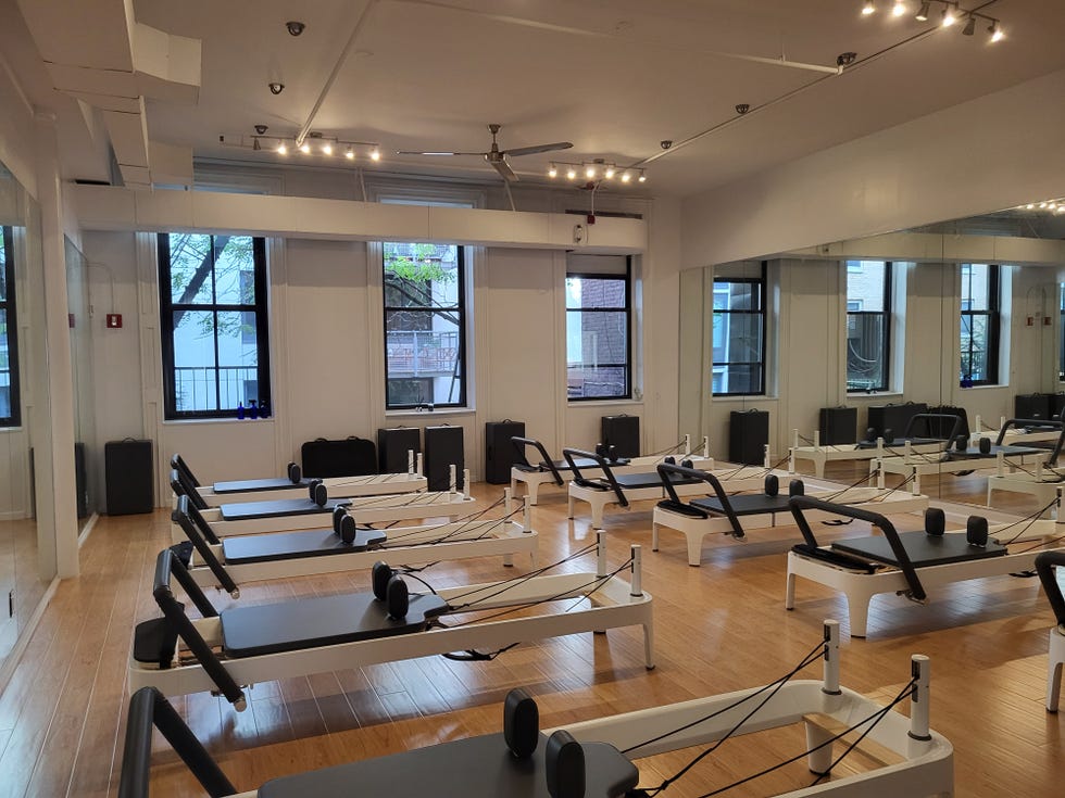 Pilates studio with reformer machines and natural light