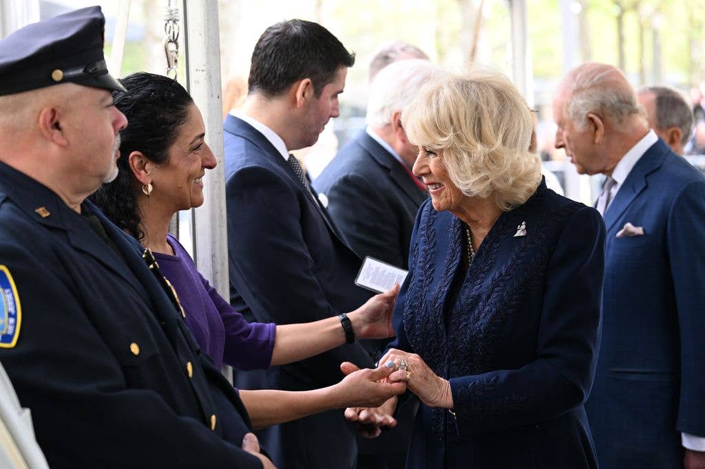 Queen Camilla holding hands with Anthoula, the sister of a 9/11 victim