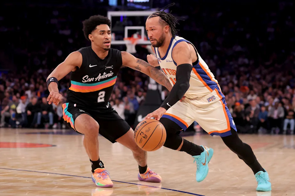 New York Knicks guard Jalen Brunson (11) drives to the basket against San Antonio Spurs guard Dylan Harper.