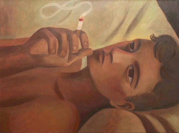 Person lying down, holding a lit cigarette with a thoughtful expression, surrounded by soft pillows in warm lighting.