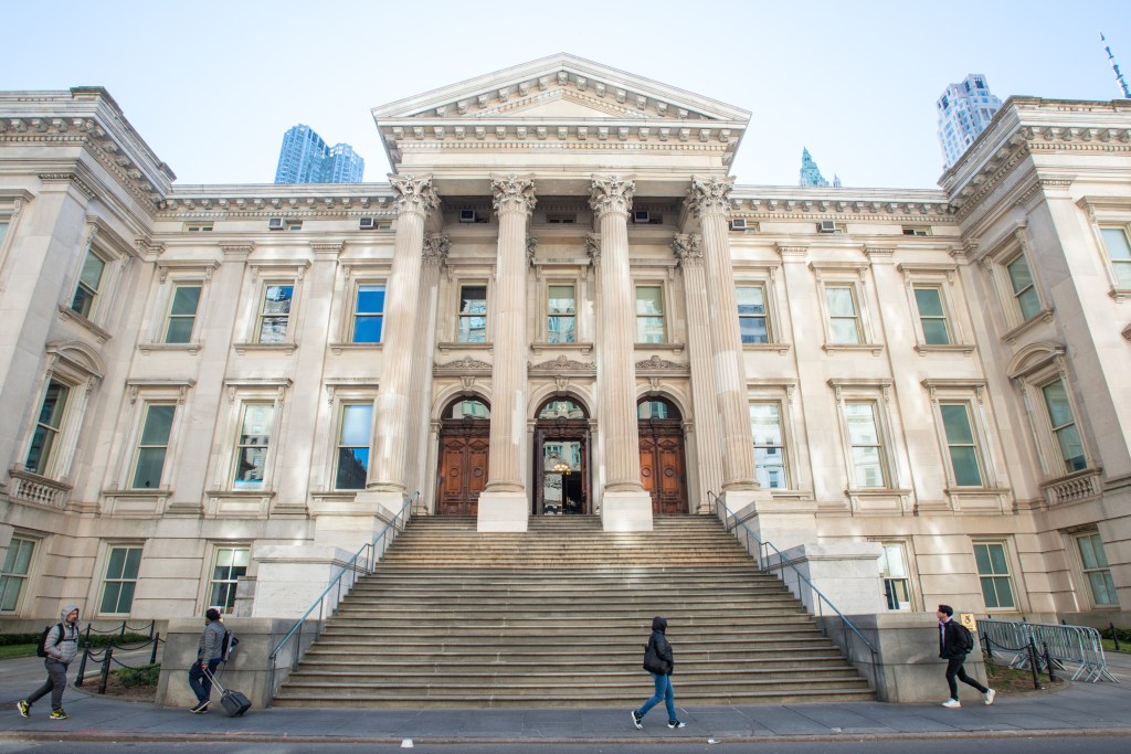 Tweed Courthouse in New York City with people walking outside.