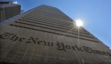 The sun peaks over the New York Times Building in New York